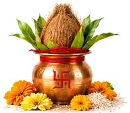 A copper kalash with a swastika, topped with mango leaves and a coconut, surrounded by marigolds and rice